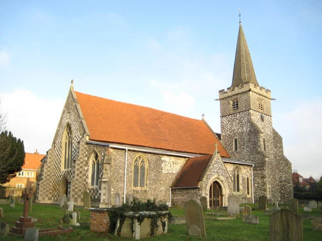 Picturesque view of Burnham village high street with historic buildings and tree-lined streets