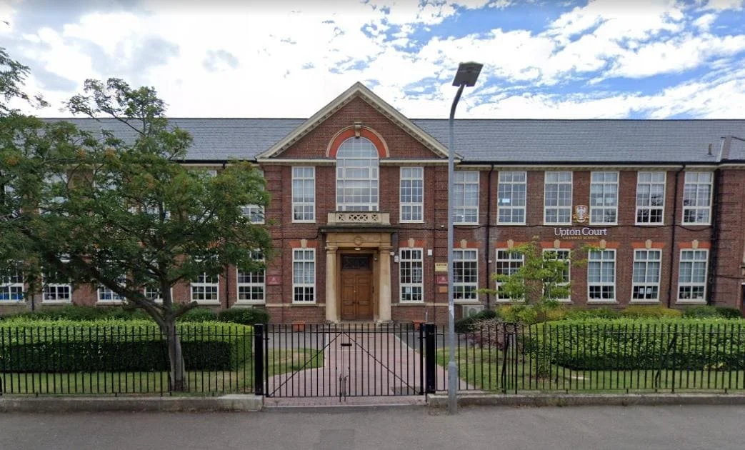 Impressive entrance of a prestigious grammar school in Slough with students walking through the gates